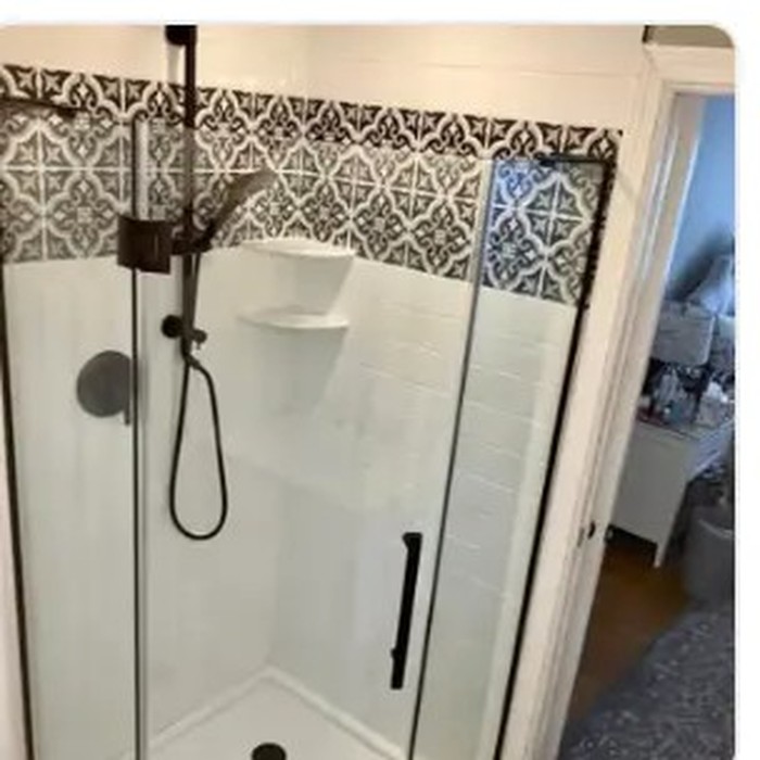 Glass shower enclosure finished with new fixtures